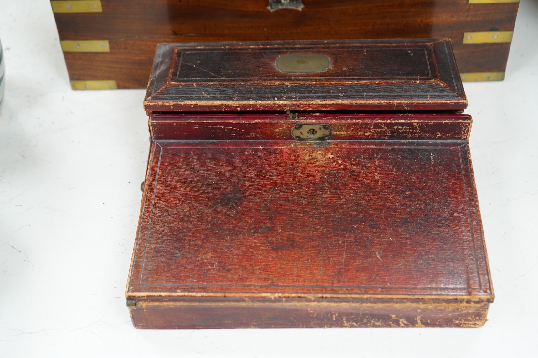 A Victorian brass bound mahogany writing slope and a Regency leather covered writing slope, 50cm wide